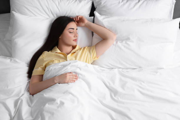 istock Beautiful young woman sleeping in soft bed, above view 1745861633
