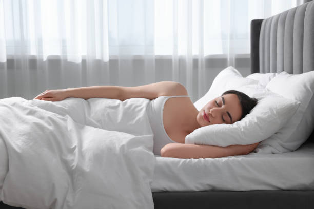 istock Beautiful young woman sleeping in soft bed at home 1745861651