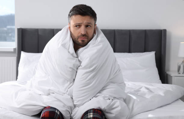 istock Sleepy man wrapped in blanket on soft bed at home in morning 1745863852