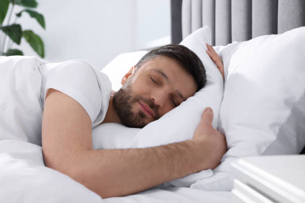istock Handsome man sleeping in soft bed at home 1745864363