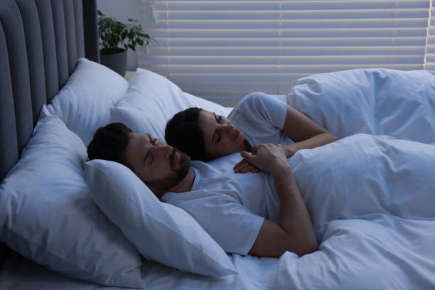 istock Lovely couple sleeping together in bed at night 1745864382