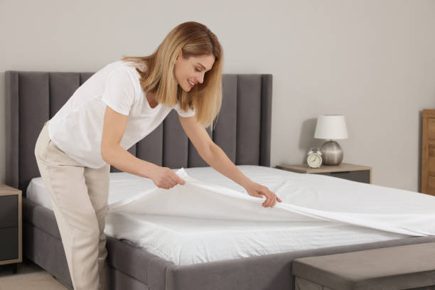 istock Woman changing bed linens at home. Space for text 1745864899