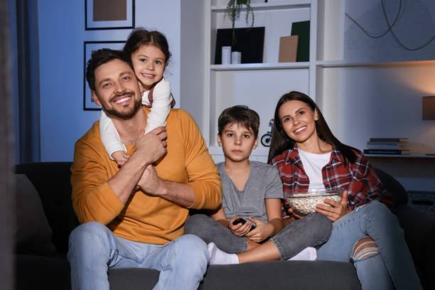 istock Family watching TV at home in evening 1745870759