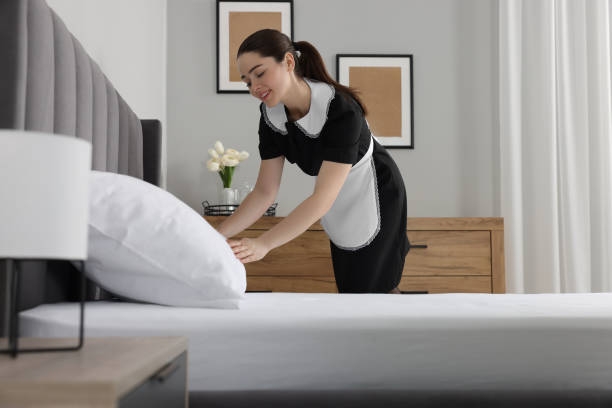 istock Young chambermaid making bed in hotel room 1745880084