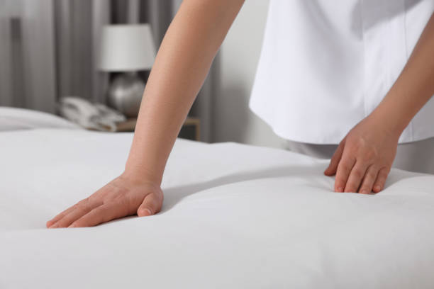istock Maid making bed in hotel room, closeup 1745881197