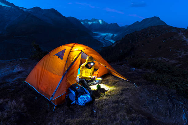 istock Hiker with tent preparing meal, Aletsch glacier, Switzerland 1745908733
