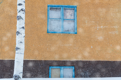 Winter scenery in the abandoned house with blue window fixtures, Swedish Lapland, Sweden