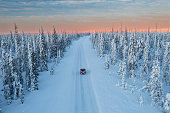 Aerial view of a car crossing a mountain pass in the Swedish Lapland.