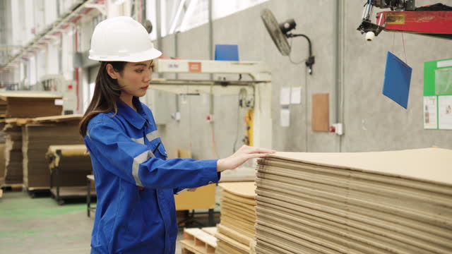 Industrial factory workers Cardboard Paper factory engineer inspecting large machines Conveying paper production line