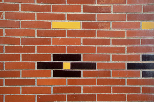 line red brick wall with black and yellow wall stone facade background of bricks horizontal stones wallpaper