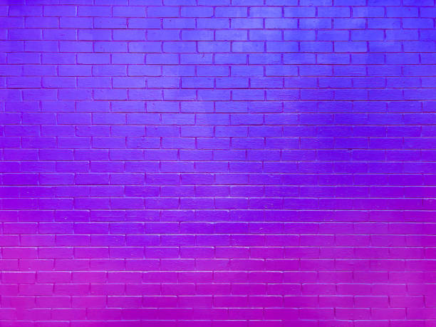 istock Brightly colored brick wall painted neon pink and purple with a gradient creating a wave of color. 1745954538