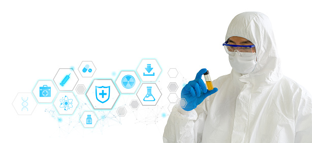 Epidemiological researchers in virus protective clothing holding glass bottle contain yellow chemical, showing symbol of medicine innovation, treatment, discovery and healthcare analysis.