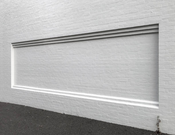 A billboard space built into the brick facade of a building creating a blank canvas for art or advertising.