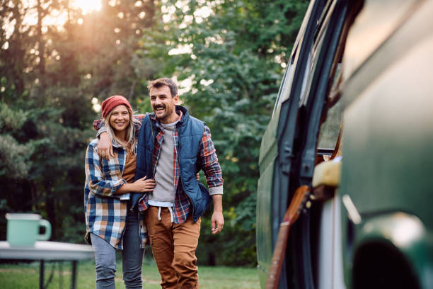 istock Happy man and his girlfriend walking embraced at camper trailer park. 1746001745