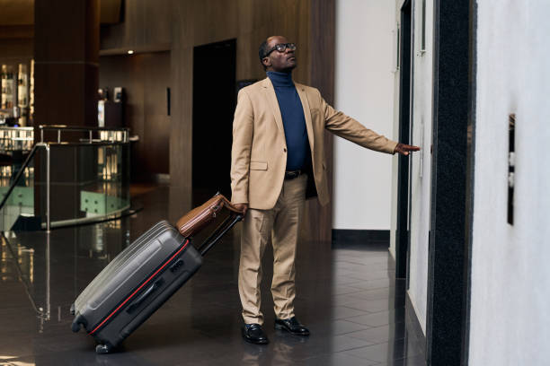 istock Man with luggage waiting for the elevator 1746007383