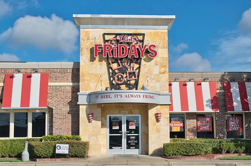 Houston, Texas USA 09-24-2023: TGI Friday's restaurant storefront exterior in Houston, TX. American casual dining franchise founded in 1965.