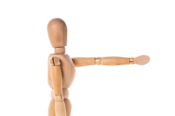 istock A wooden mannequin is depicted pointing at something. This versatile image can be used to represent directions, instructions, guidance, or any situation requiring a visual cue. 1746011709