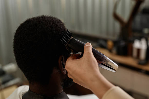 istock Barber using trimmer to cut hair 1746019379