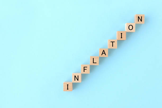 istock Wooden blocks with INFLATION word on light blue background 1746021503