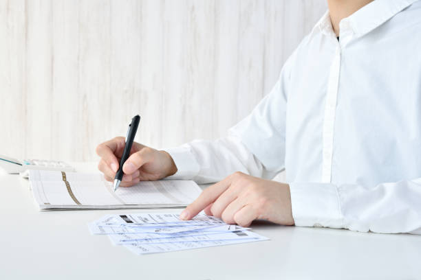 istock Woman writing on household account book 1746022655