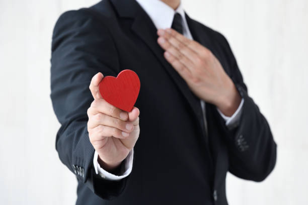 istock Business man holding heart object with hand on chest 1746023260