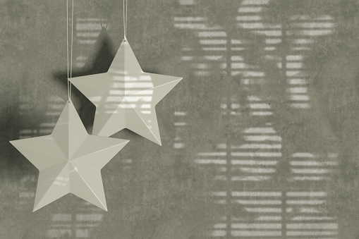 Christmas ornament star shape on gray color background, new year concept. Digitally generated image.