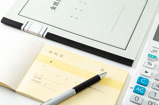 Cash book and calculator on a white background.