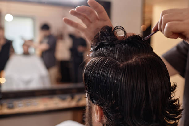 istock Barber combing hair of customer 1746051158