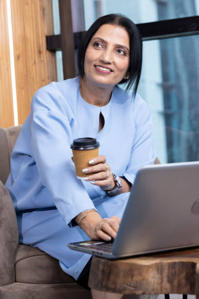 istock Businesswoman using laptop on sofa at office 1746055726