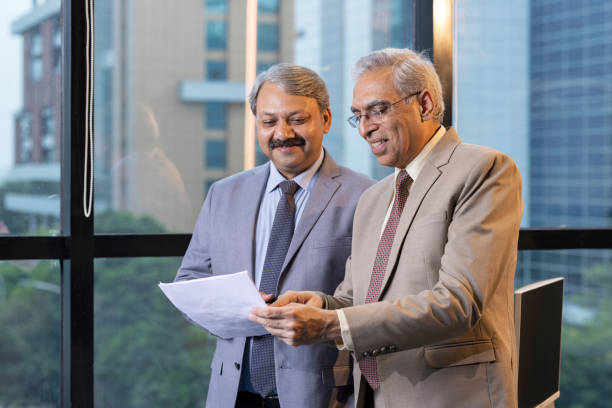 istock Two businessman discussing paper document with executive manager. 1746055731