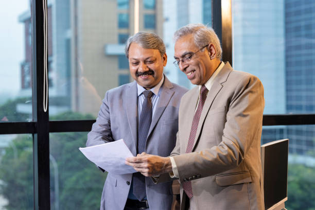 istock Two businessman discussing paper document with executive manager. 1746057377