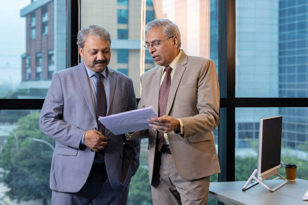 istock Two businessman discussing paper document with executive manager. 1746057381