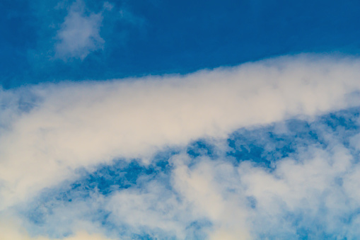 Cotton-like white clouds that form after the flight of an airplane. The impact of scientific developments on the weather and on nature in general, the consequences of experiments.