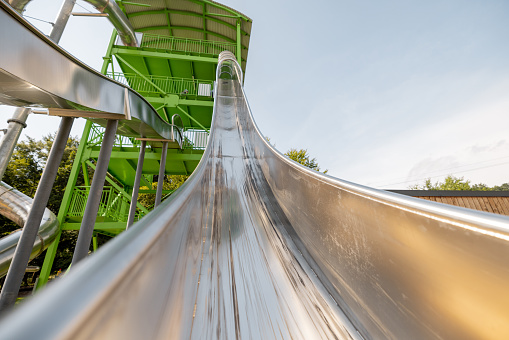 Children's slide made of stainless steel in the amusement park, view from below