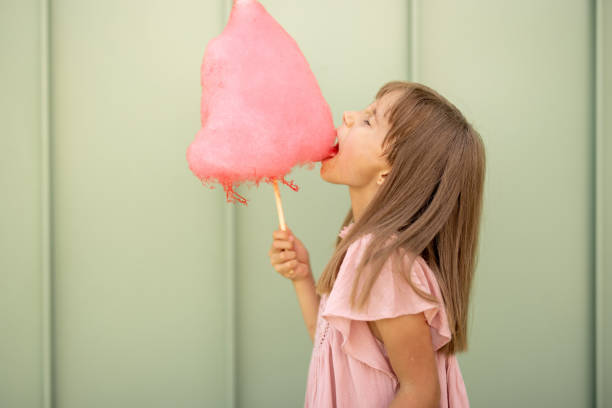 istock Little girl with pink cotton candy 1746067980