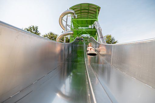 Children's slide made of stainless steel in the amusement park, view from below