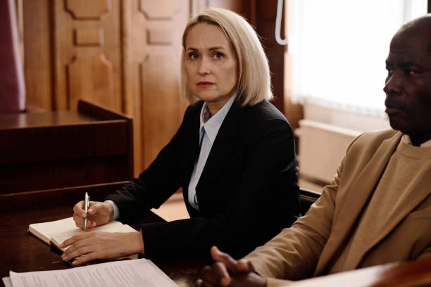 istock Blond female jury or prosecutor looking at camera and making notes 1746070966