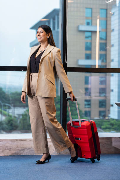istock Smiling Flight Attendants with Suitcase in Airport 1746078555