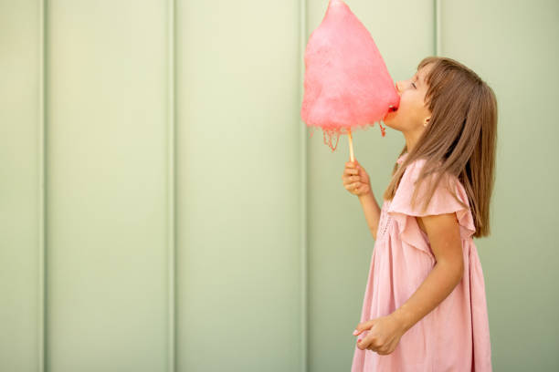 istock Little girl with pink cotton candy 1746086322