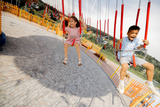 istock Kids riding on colorful amusement carousel 1746089010