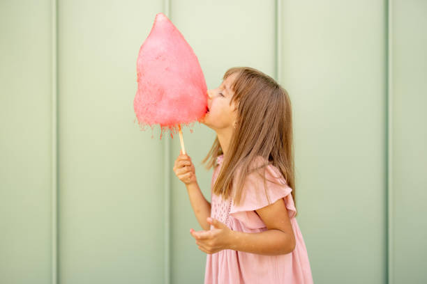 istock Little girl with pink cotton candy 1746089704