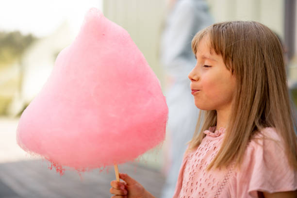 istock Little girl with pink cotton candy 1746090920