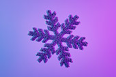 Snowflake shape with particles Christmas ornament on neon background, new year concept