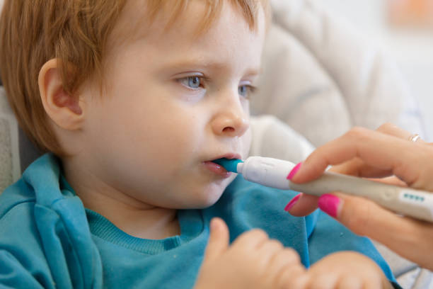 istock Blond toddler with special spoon in his mouth, feeding therapy aid 1746116566