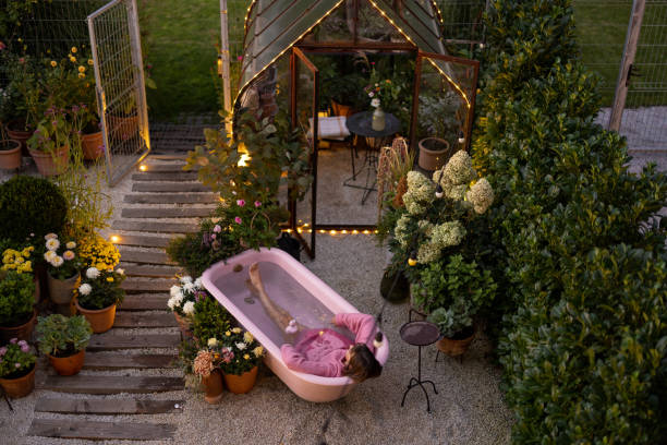 Cozy backyard with a woman bathing in pink bathtub