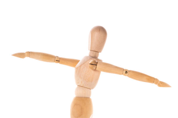 istock A wooden mannequin stands on a clean, white surface. This versatile image can be used for various purposes. 1746120458