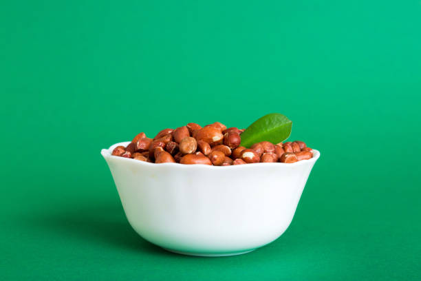istock Fresh healthy peanuts in bowl on colored table background. Top view Healthy eating bertholletia concept. Super foods 1746122114