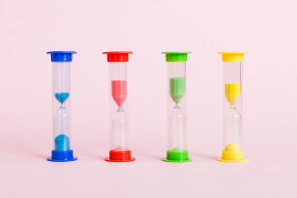 hourglass on the table, sand clock as time passing concept for business deadline, copy space - hourglass time purple deadline imagens e fotografias de stock