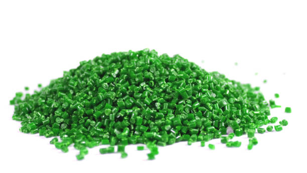 istock Secondary granule made of polypropylene, green Plastic pellets crumbles to the table. Plastic raw materials in granules for industry. Polymer resin. Raw plastic recycling concept 1746126181