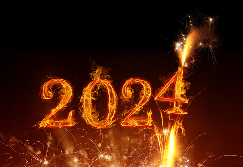 Fire inscription and fireworks of year 2024 - Happy New Year